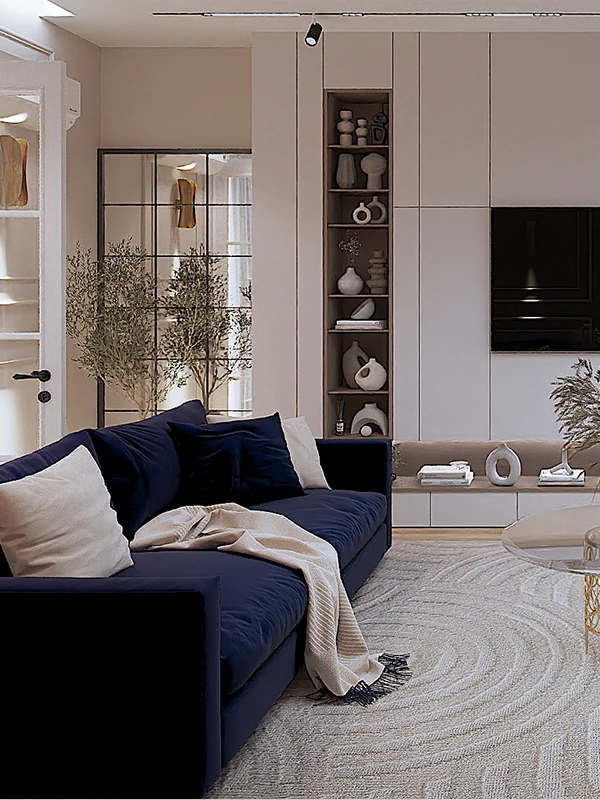 Kontakto 3 Dhomë ndenje moderne me divan të madh ngjyrë blu të errët, tapet të rrumbullakët me teksturë, pemë ulliri dekorative dhe mur të bardhë me rafte të integruara - Interior design elegant nga Studio Arkitekture